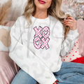 A pink checkered XO XO Valentine design with heart‑filled letters, perfect for cute and cozy February apparel.