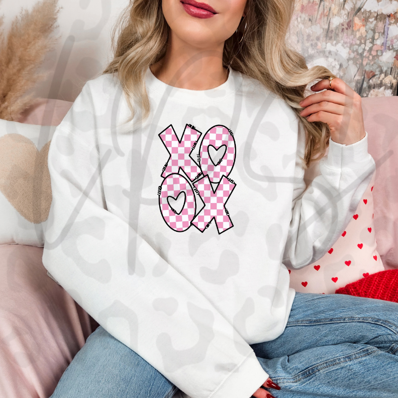 A pink checkered XO XO Valentine design with heart‑filled letters, perfect for cute and cozy February apparel.