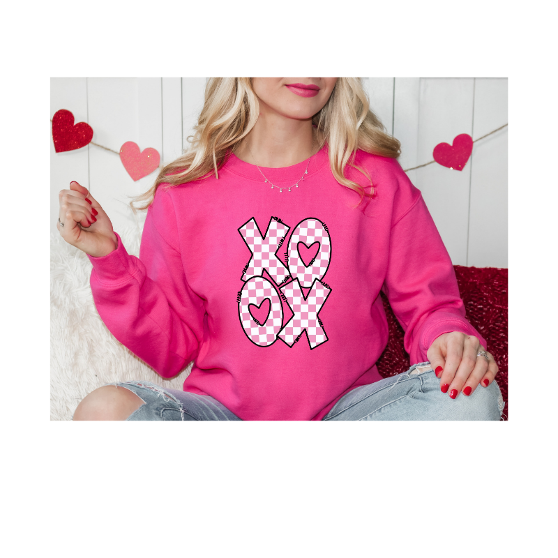 A pink checkered XO OX Valentine design featuring heart‑filled letters in a cute modern layout.