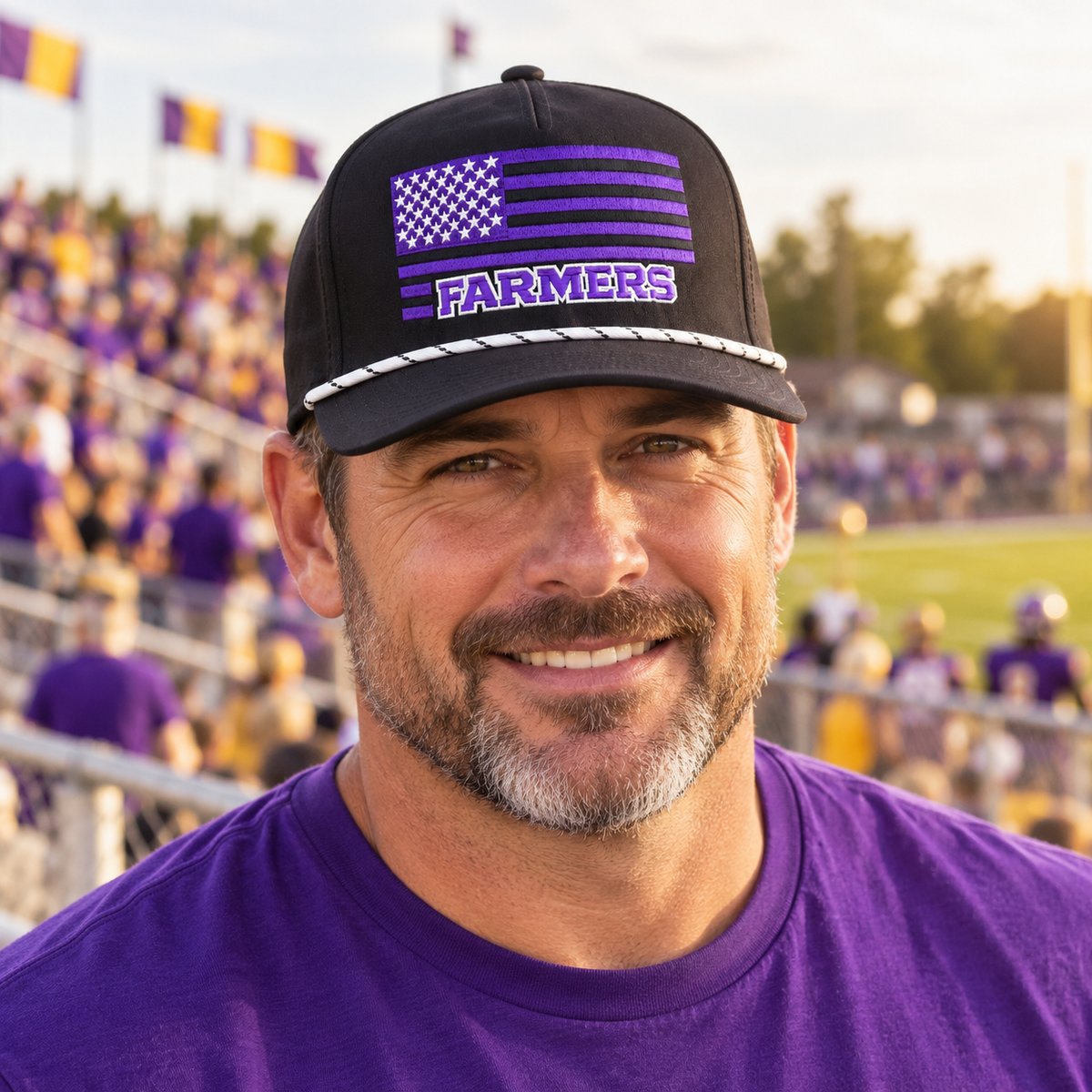 Adult fan wearing the Farmersville Luna Farmers Flag cap at a purple-and-gold game-day stadium — lifestyle mockup